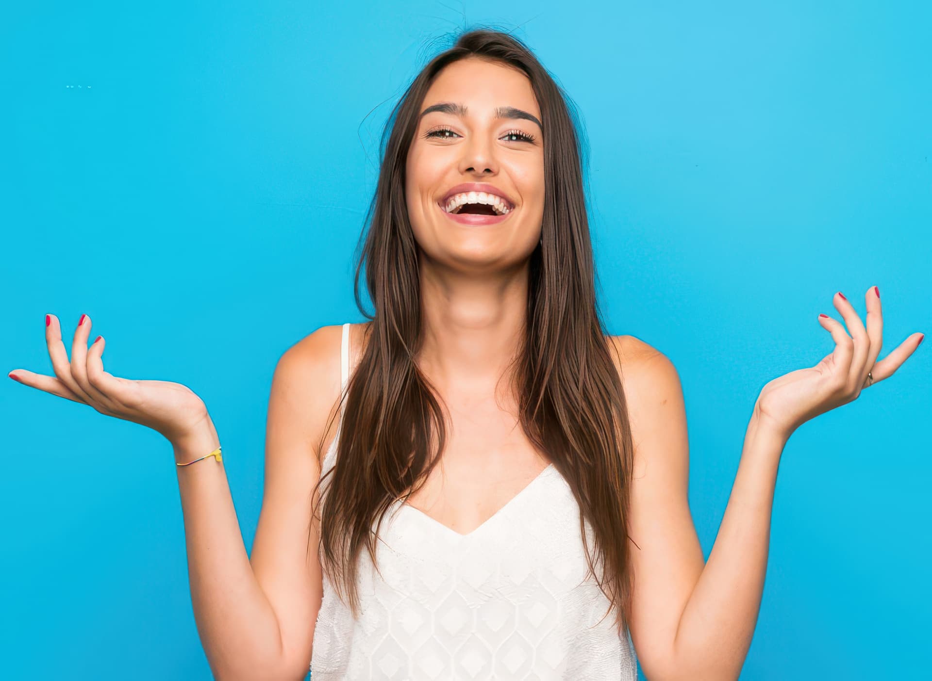 Happy patient smiling with hands raised at Nest Dental St Leonards